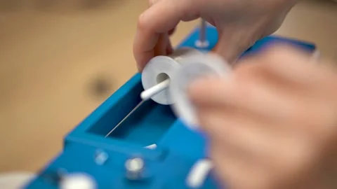 Seamstress attaching transparent thread to a sewing machine Stock Footage 222172388
