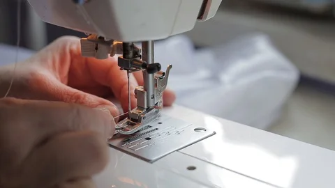 Seamstress can’t get the thread into the needle of the sewing machine Stock Footage 128244292