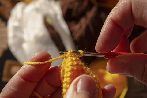 Seamstress crocheting wool close-up. Manual work and hobbies. A knitter is se Stock Photos