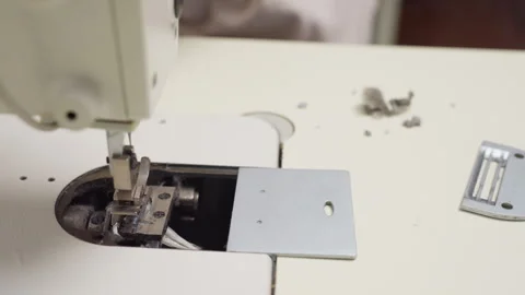 Seamstress Cutting Thread from Bobbin Compartment of Sewing Machine Stock Footage 307137266