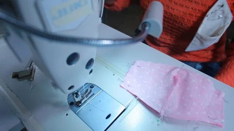 Seamstress hands preparing the boot of a sewing machine. COVID 19 Stock-Footage 128164604