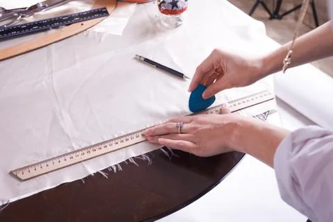 The seamstress makes a pattern for the future product. Sewing workshop. Stock Photos
