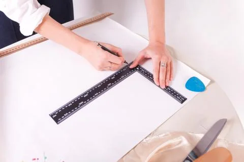 The seamstress makes a pattern for the future product. Stock Photos