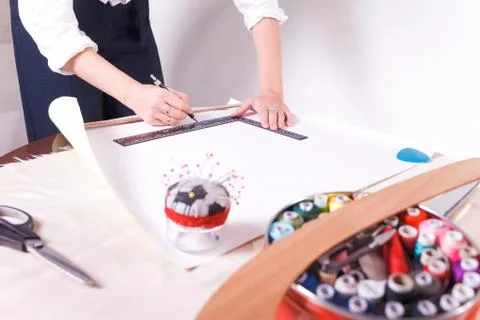 The seamstress makes a pattern for the future product. Sewing workshop. Stock Photos