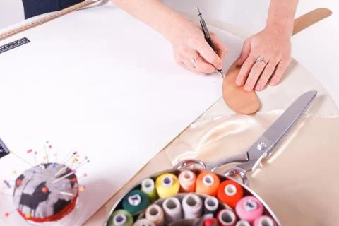 The seamstress makes a pattern for the future product. Sewing workshop. Stock Photos