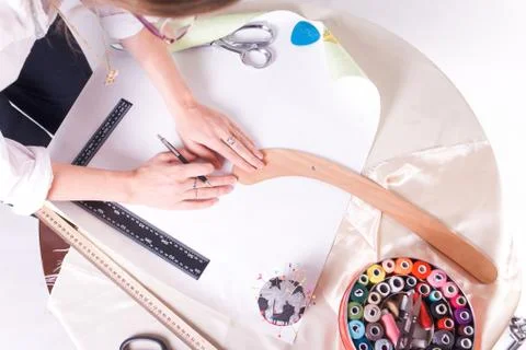 The seamstress makes a pattern for the future product. Sewing workshop. Stock Photos