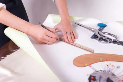 The seamstress makes a pattern for the future product. Sewing workshop Stock Photos