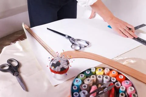 The seamstress makes a pattern for the future product. Sewing workshop. Stock Photos