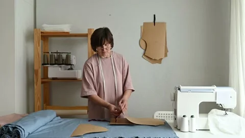 Seamstress making clothes pattern in workshop Stock Footage 208830850