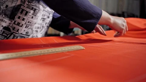Seamstress making pattern on fabric Stock Footage 107376570