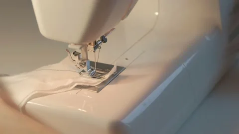 Seamstress making testing stitches on piece of fabric before working, closeup. Stock Footage 136931043