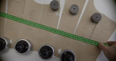 Seamstress Measuring Pattern with Measuring Tape Close Up Stock Footage 316163528