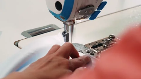 Seamstress neck clothes on a sewing machine. Close up view of the presser foot Stock Footage 199306865