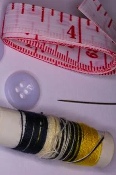 Seamstress Objects including a needle, thread, and tape Stock Photos