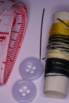 Seamstress Objects including a needle, thread, and tape Stock Photos