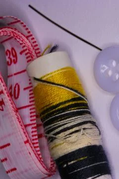 Seamstress Objects including a needle, thread, and tape Stock Photos