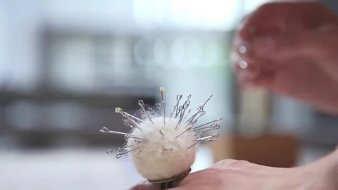 Seamstress prepares pins for cutting patterns before seawing, handmade dress and Stock Footage 78001273
