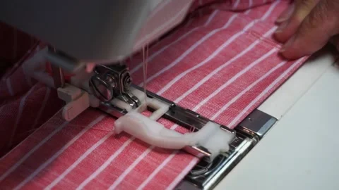Seamstress processes buttonhole on sewing machine Stock Footage 196977578