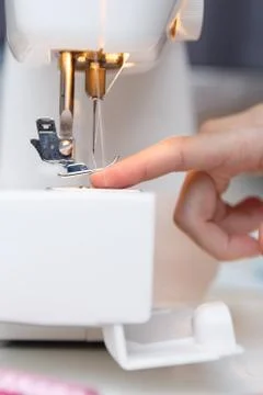 Seamstress put thread in needle Stock Photos