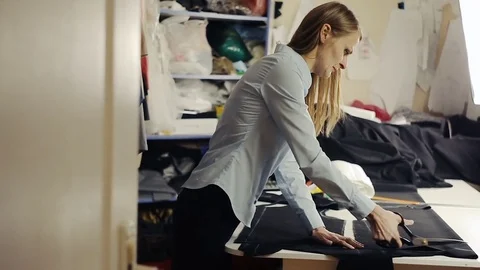 Seamstress with scissors cutting fabric Stock Footage 82931372