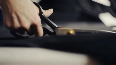 Seamstress with scissors cutting fabric Video stock 82931819