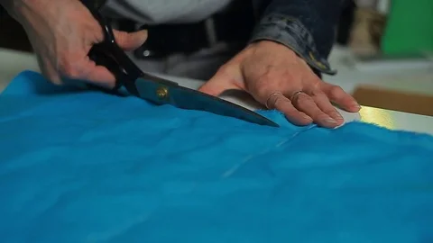 Seamstress with scissors cutting fabric Stock Footage 83443121