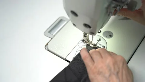 A seamstress scribbles on an automatic sewing machine and cuts the threads 스톡 동영상 223379248