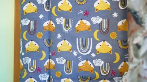 Seamstress selecting children's textile rolls with cute colorful patterns Video stock 339754804