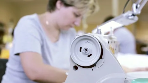 Seamstress sewing on the sewing machine Stock Footage 73148768
