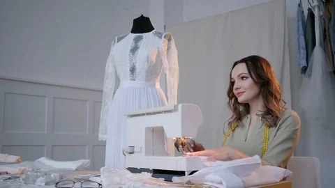 A seamstress sews clothes in the spacious Studio Stock Footage 127015752