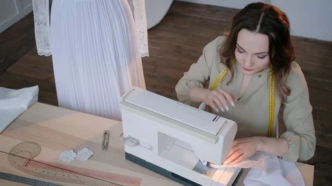 A seamstress sews clothes in the spacious Studio Stock Footage 127477068