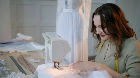 A seamstress sews clothes in the spacious Studio Stock Footage 127477969