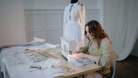 A seamstress sews clothes in the spacious Studio Stock Footage 127478376