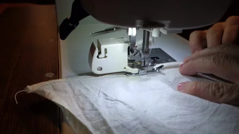 Seamstress sews on an electric sewing machine Stock Footage 166122995