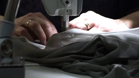Seamstress sews on a sewing machine Видео 94137709