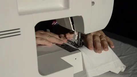 Seamstress sews on a sewing machine Stock Footage 122919688