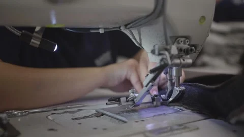 The seamstress sews on a sewing machine Stock Footage 164478833