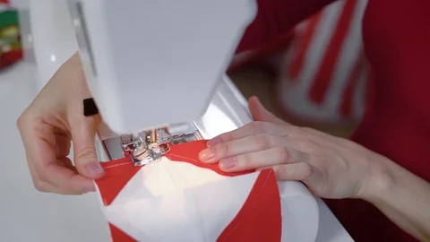 Seamstress is stitching by sewing machine part of patchwork quilt, directing Stock Footage 82533302
