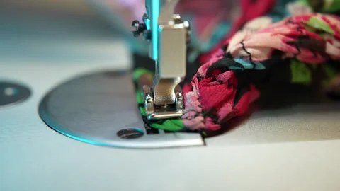 Seamstress stitching on sewing machine in workshop, close-up shot of dressmaker Stock Footage 252427541