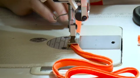 Seamstress Stitching Strip, Using Sewing Machine. Red Fabric Under the Needle. Stock Footage 68029925