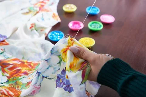 Seamstress tailor using beads decorating dress in atelier Stock Photos