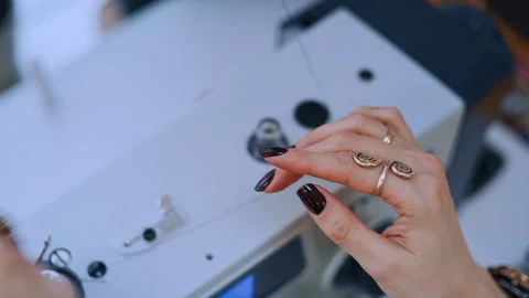 Seamstress threading sewing machine in studio Видео 335932064