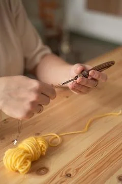 The seamstress threads the thread into a large sewing needle Stock Photos