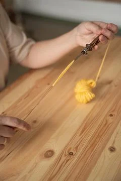 The seamstress threads the thread into a large sewing needle Stock Photos