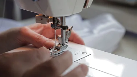 Seamstress try threading a needle in a sewing machine Stock Footage 128244182