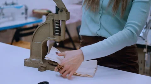 Seamstress using a press machine for fabric in her studio Видео 335932986