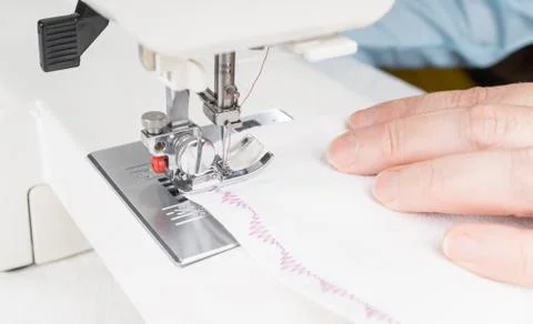 Seamstress using sewing machine, close-up Stock Photos