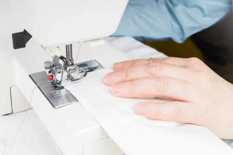 Seamstress using sewing machine, close-up Stock Photos