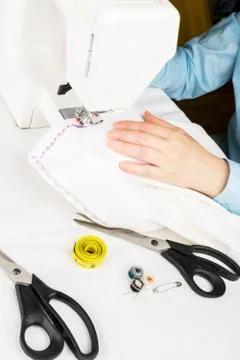 Seamstress using sewing machine, close-up Stock Photos