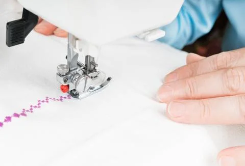 Seamstress using sewing machine, close-up Stock Photos